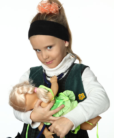 Little girl holding doll
